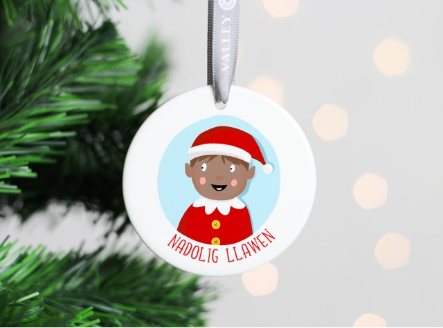 White ceramic christmas tree decoration with the image of a boy elf